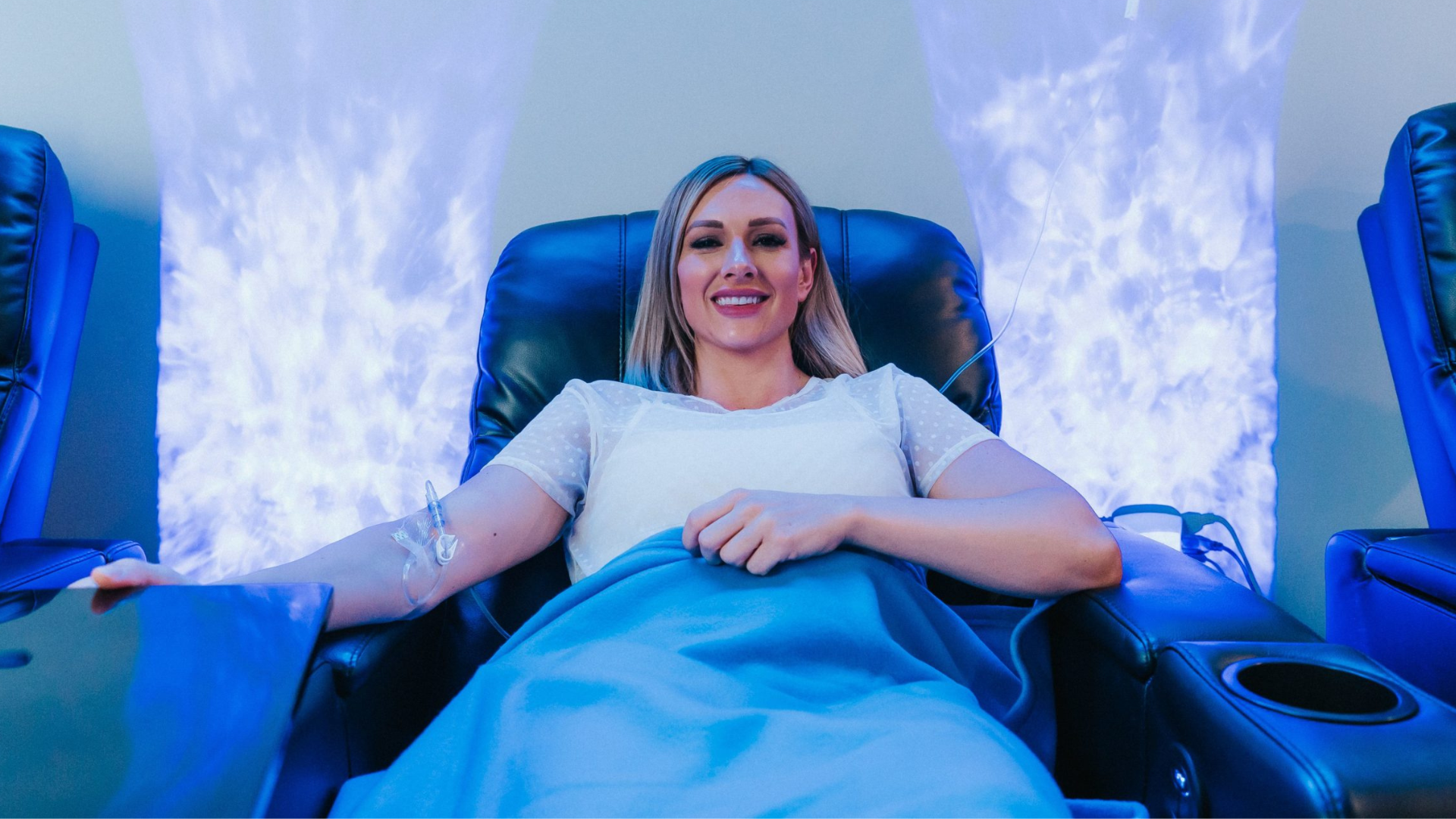 Patient receiving IV infusion therapy in a comfortable wellness lounge setting